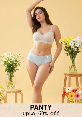 A woman modeling light grey seamless bra and panty set in minimal studio background